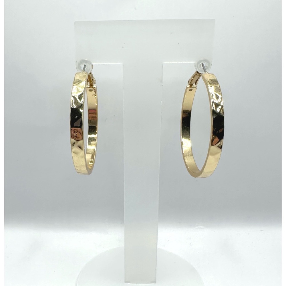 Gold Tone textured hoop earrings featuring a hammered or diamond-cut design